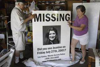 Jesus and Georgette Sanchez take a large poster of their missing daughter, Jeanine Harms-Sanchez, out of storage from their Campbell home in July 2003. A suspect was arrested today in the case.